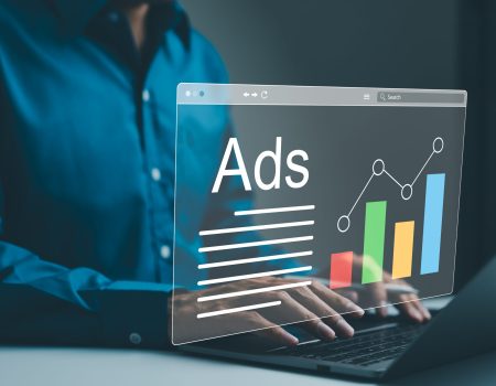 Ad on website and social media, banner ads on internet, Digital marketing concept. Marketer analyzing online advertising campaigns and performance metrics on a laptop with a graphical data interface.