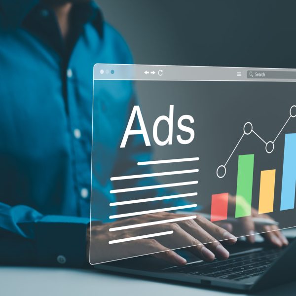 Ad on website and social media, banner ads on internet, Digital marketing concept. Marketer analyzing online advertising campaigns and performance metrics on a laptop with a graphical data interface.