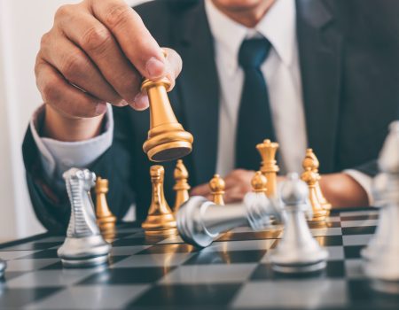 Businessman leadership playing chess and thinking strategy plan about crash overthrow the opposite team and development analyze for successful of corporate.