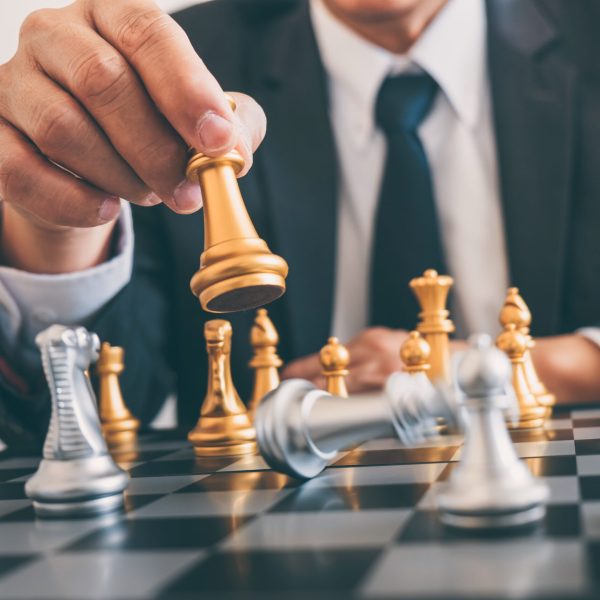 Businessman leadership playing chess and thinking strategy plan about crash overthrow the opposite team and development analyze for successful of corporate.